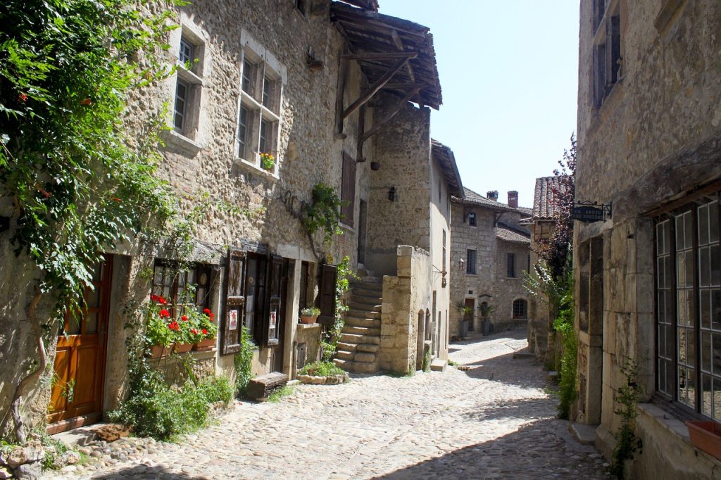 An empty cobbled street in the medieval village of Perouges on a quiet Sunday