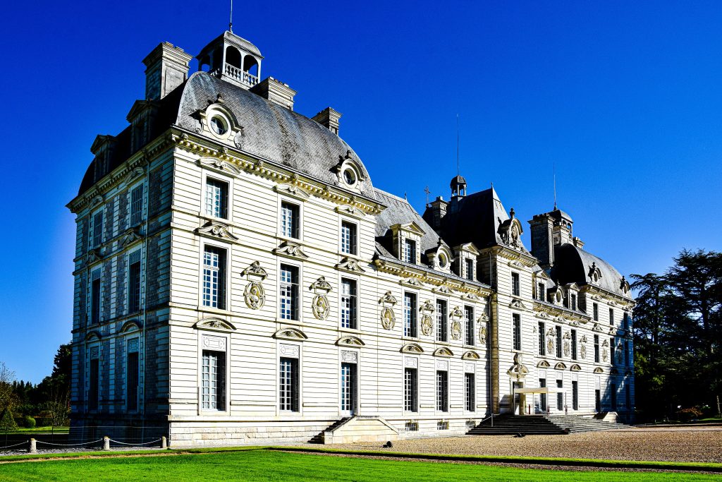 Cheverny Castle in France basking in sunlight with clear blue skies.