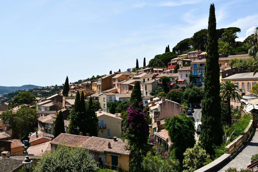 Picturesque view of Bormes-les-Mimosas with colorful houses and lush greenery.