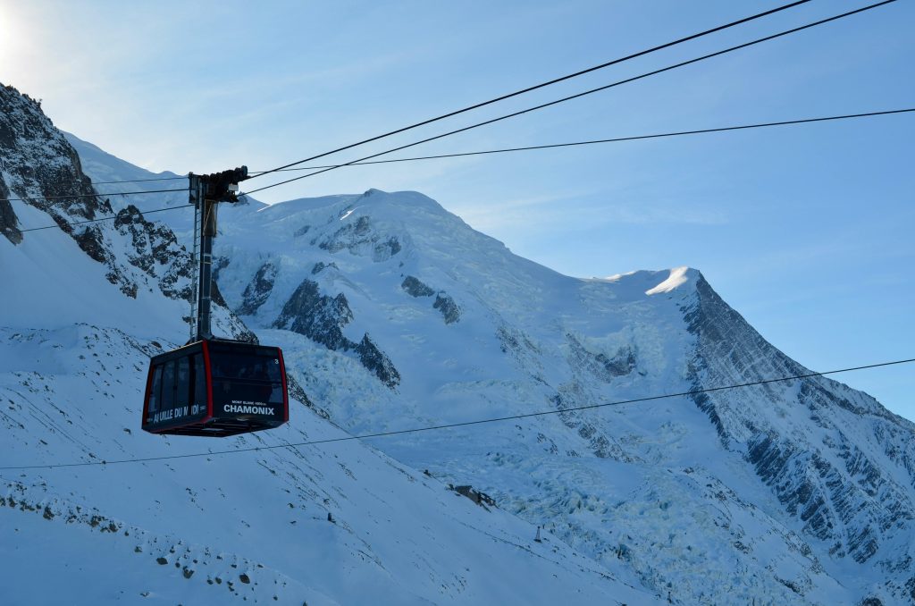 Cable car ascending Aiguille du Midi with Mont Blanc as a backdrop in winter, Chamonix.