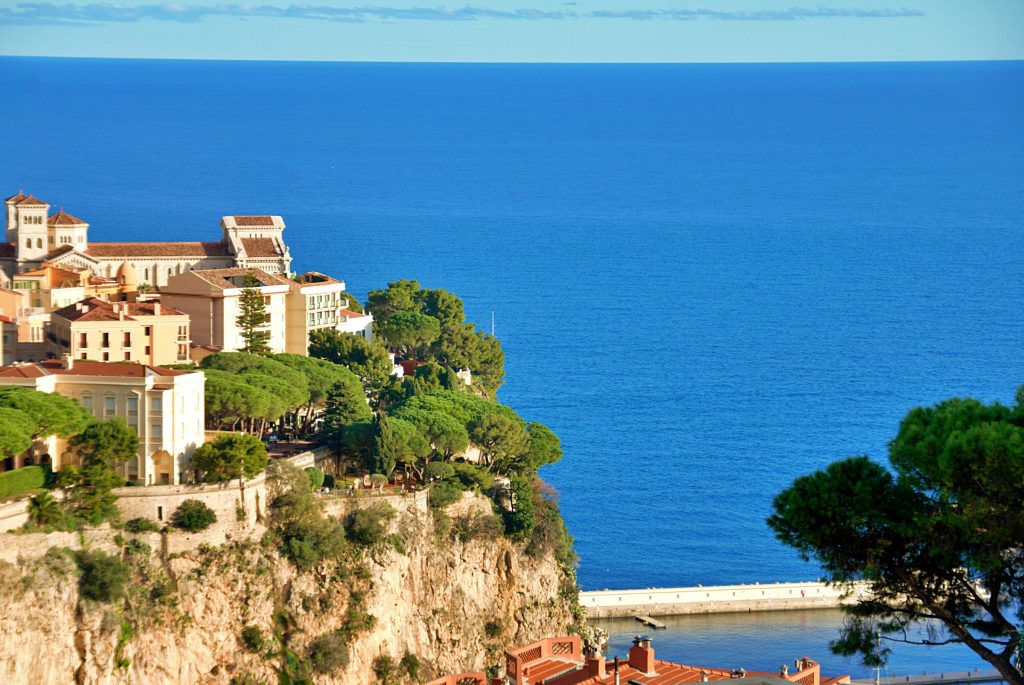 A stunning aerial view of the Monaco coastline featuring lush greenery and historic architecture.