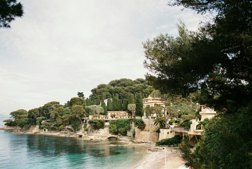 Idyllic coastal scene of Paloma Beach with lush greenery and elegant villas.