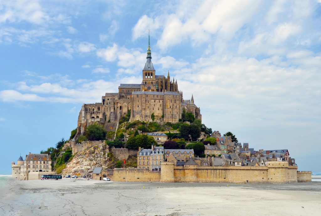 Capture of Le Mont-Saint-Michel Abbey, a stunning island commune in France under a vibrant sky.