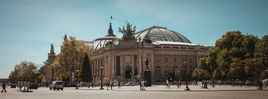 A captivating view of the Grand Palais in Paris, showcasing its iconic architecture under a clear blue sky.